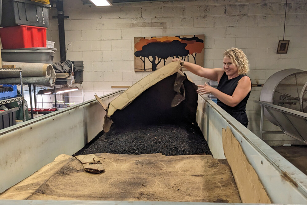 a bin of worms being shown of by Jen Mastalerz, co-owner of Bennett Compost